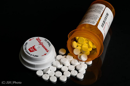 Prescription Bottle on its Side with Pills Spilling Out