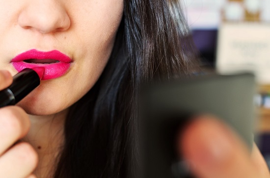 Woman Applying Lipstick